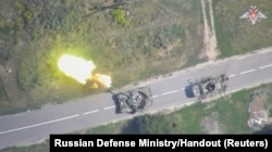 An aerial view shows what is said to be a firing Ukrainian tank in the area bordering Ukraine in the Kursk region, Russia, in this still image from video released Aug. 11, 2024.