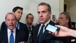 FILE - Hunter Biden talks to reporters while leaving a House Oversight Committee hearing on Capitol Hill in Washington, Jan. 10, 2024. 