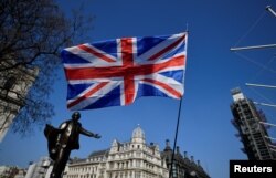 A British flag flutters in Parliament Square in London, March 29, 2019.