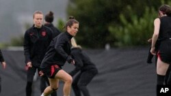 United States' Kelley O'Hara, front left,, takes part in drills during practice for the FIFA Women's World Cup, at Bay City Park in Auckland, New Zealand, July 21, 2023.