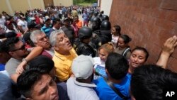 Neighbors and voters gather at a polling station after electoral authorities delayed its opening due to alleged electoral violations during general elections in San Jose El Golfo on the outskirts of Guatemala City, June 25, 2023.