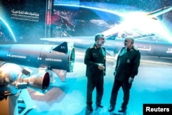 Commander-in-Chief of the Islamic Revolution Guards Corps Hossein Salami and IRGC Aerospace Force Commander Amir Ali Hajizadeh stand next to the new hypersonic ballistic missile called Fattah, in Tehran, Iran, June 6, 2023. (IRGC/WANA/Handout via Reuters)