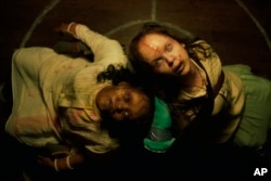 Aktris Lidya Jewett, kiri, dan Olivia O'Neill dalam sebuah adegan di "The Exorcist: Believer." (Universal Pictures/AP)
