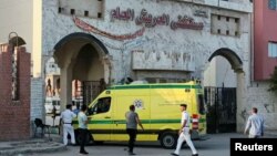 Security guards check an Egyptian ambulance carrying critically injured Palestinians as they arrive at Al-Arish hospital through the Rafah border crossing, in the city of Al-Arish, Sinai Peninsula, Egypt, Nov. 1, 2023.