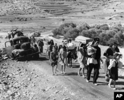 FILE - Arab refugees leave from Palestine on the Lebanon Road, Nov. 4, 1948, during fighting in Galilee between Israel and Arab troops. (AP/Jim Pringle)