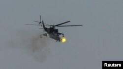 A Ukrainian military helicopter fires during drills in the north of Ukraine, June 1, 2023.