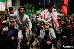 Released Palestinian prisoners react after leaving the Israeli military prison, Ofer, near Ramallah in the Israeli-occupied West Bank, Nov. 26, 2023.