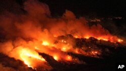 FILE - Fire consumes an area next to the Transpantaneira road in the Pantanal wetlands near Pocone, Mato Grosso state, Brazil, Nov. 15, 2023.