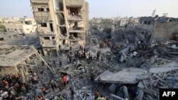 People check the damage caused by an Israeli strike on the Al-Maghazi refugee camp in Deir Balah in the central Gaza Strip, on Nov. 5, 2023.