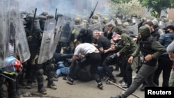 NATO Kosovo Force (KFOR) soldiers clash with local Kosovo Serb protesters at the entrance of the municipality office, in the town of Zvecan, Kosovo, May 29, 2023.