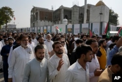 Shiite Muslims take part in a demonstration against Israeli airstrikes on Gaza to show solidarity with Palestinian people, in Islamabad, Pakistan, Oct. 13, 2023.