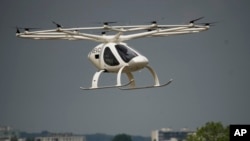 The Volocopter 2X, an electric vertical takeoff and landing multicopter, performs a demonstration flight during the Paris Air Show in Le Bourget, north of Paris, France, Monday, June 19, 2023. (AP Photo/Lewis Joly)