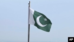 FILE - A Pakistani flag flies at a lookout in Islamabad, Pakistan, on July 27, 2022. 