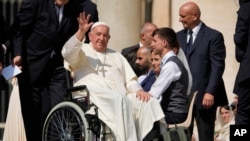 Pope Francis waves as he leaves after his weekly general audience in St. Peter's Square at The Vatican, Aug.28, 2024. 