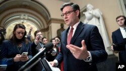 U.S. Speaker of the House Mike Johnson reads a statement to reporters about efforts to complete the appropriations process, at the Capitol in Washington, Jan. 12, 2024.