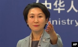 In this image made from video, Chinese Foreign Ministry spokesperson Mao Ning gestures during a press conference in Beijing, Jan. 16, 2024.