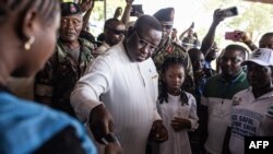 Incumbent President of Sierra Leone, Julius Maada Bio, casts his vote in Freetown on June 24, 2023 during the presidential vote.