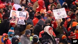 FILE - Kansas City Chiefs fans who braved sub-zero temperatures celebrate after a touchdown against the Miami Dolphins during the first half of an NFL wild-card playoff football game, in Kansas City, Missouri, Jan. 13, 2024.