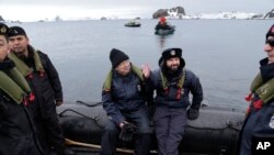 Chile's President Gabriel Boric, center right, and UN Secretary-General Antonio Guterres sit on a boat at King George Island, South Shetlands, Antarctica, Nov. 23, 2023.