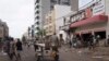 People stand at the entrance of a destroyed supermarket in Dakar, Senegal, June 3, 2023. 