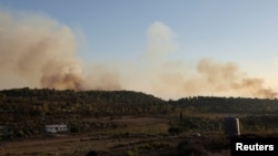 Smoke rises after Israeli shelling, as seen from Lebanese side near the border with Israel in Alma Al-Shaab, southern Lebanon, Oct. 13, 2023.
