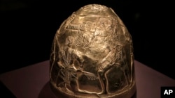 FILE - A Scythian gold helmet from the fourth century B.C. is displayed as part of an exhibit called Crimea - Gold and Secrets of the Black Sea, at the Allard Pierson historical museum in Amsterdam, April 4, 2014. The collection has now made its way back to Ukraine.