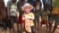 FILE - A 3-year-old boy with albinism is seen with his friends at their family home in this May, 23, 2016, photo in Machinga, Malawi.