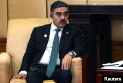 FILE - Pakistan's caretaker Prime Minister Anwar-ul-Haq Kakar attends a meeting in Beijing, China, Oct. 17, 2023. (Sputnik/Sergei Guneev/Pool via Reuters)