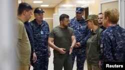 FILE - Ukrainian President Volodymyr Zelenskyy speaks with Major-General Tetiana Ostashchenko as he visits a military hospital in the town of Ochakiv, in Ukraine's in Mykolayiv region, July 27, 2023. (Ukraine's Presidential Press Service via Reuters)