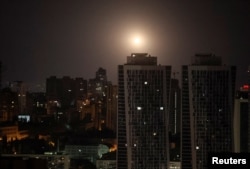 An explosion is seen in the sky over the city during a Russian missile and drone strike in Kyiv, Ukraine, Aug. 11, 2024.
