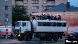 Rescuers evacuate local residents from a flooded area after the Nova Kakhovka dam breached, amid Russia's attack on Ukraine, in Kherson, Ukraine, June 6, 2023.