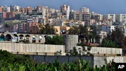 FILE - A general view of the concrete wall surrounding the Ein el-Hilweh Palestinian refugee camp near the southern port city of Sidon, Lebanon, May 5, 2017. 
