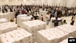 FILE - Volunteers help pack aid for the Gaza Strip at a donation center set up by the Emirates Red Crescent in Dubai, UAE, Oct. 21, 2023.
