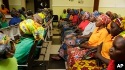 FILE - In this May 8, 2017, file photo, schoolgirls freed from Boko Haram captivity gather in Abuja, Nigeria.
