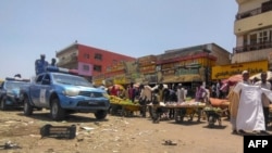 Sudanese police patrol the main market of Wad Madani, 200 km south of Khartoum, June 24, 2023. The United Nations says nearly 1.5 million people have fled the capital since violence erupted in mid-April.
