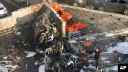 Israeli firefighters extinguish a fire after a rocket launched from the Gaza Strip hit a parking lot in Ashkelon, southern Israel, Oct. 7, 2023.