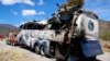 A crashed bus sits attached to a tow truck the side of the road near Villa de Tepelmeme, Oaxaca state, Mexico, Oct. 6, 2023.