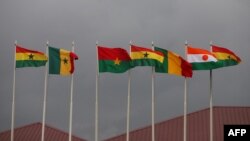 FILE - National flags of the Economic Community of West African States (ECOWAS) member states fly at Kotoka Internatinal Airport in Accra, Ghana, Sept. 15, 2020.
