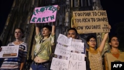 FILE - Activists hold placards during a demonstration as part of the global climate strike week, in Hanoi, Vietnam, on Sept. 27, 2019. 