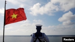 FILE - A Vietnamese naval soldier stands quard at Thuyen Chai island in the Spratly archipelago in the South China Sea on January 17, 2013.