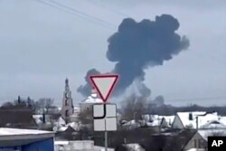 Image capture from a video showing flames rising at the scene of a Russian military transport plane that crashed near Yablonovo, Belgorod region, Russia, on on January 23, 2024. (Validated UGC video/AP)