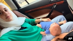 Haneen Okal, a Palestinian American who lives in New Jersey, heads toward the Rafah crossing in Egypt with her three young children, as they try to leave Gaza, where they have been trapped during a family visit, Oct. 14, 2023.