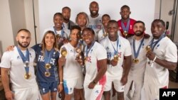 France's judo team medalists pose for a portrait during a photo session at the Champions Park at the Trocadero in Paris on Aug. 5, 2024.