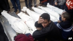 Palestinians mourn relatives killed in the Israeli bombardment of the Gaza Strip outside a morgue in Khan Younis on Jan. 4, 2024.