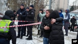 People react to a Russian attack in Kyiv, Ukraine, Jan. 23, 2024. Being a journalist in Ukraine requires getting used to air raids, which though sporadic eventually become part of normal life, American journalist Lili Bivings says.