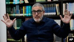 Dr. Ghassan Abu Sitta, a Palestinian British plastic surgeon specializing in conflict medicine, talks with The Associated Press at the Institute for Palestine Studies in Beirut, Dec. 9, 2023. 