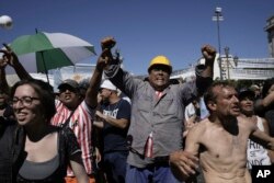 People rally outside Congress during a national strike against economic and labor reforms proposed by Argentine President Javier Milei's government in Buenos Aires, Jan. 24, 2024.
