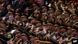 A conductor leads the military band as they perform a national anthem during the opening session of the National People's Congress (NPC) at the Great Hall of the People in Beijing, March 5, 2024.