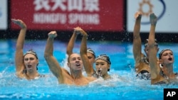 The United States team, including Bill May, front left, compete in the team acrobatic event of artistic swimming at the World Swimming Championships in Fukuoka, Japan, July 15, 2023.