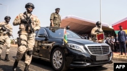 Le président Umaro Sissoco Embalo débout dans sa voiture lors du cinquantième anniversaire de l'indépendance de la Guinée-Bissau.